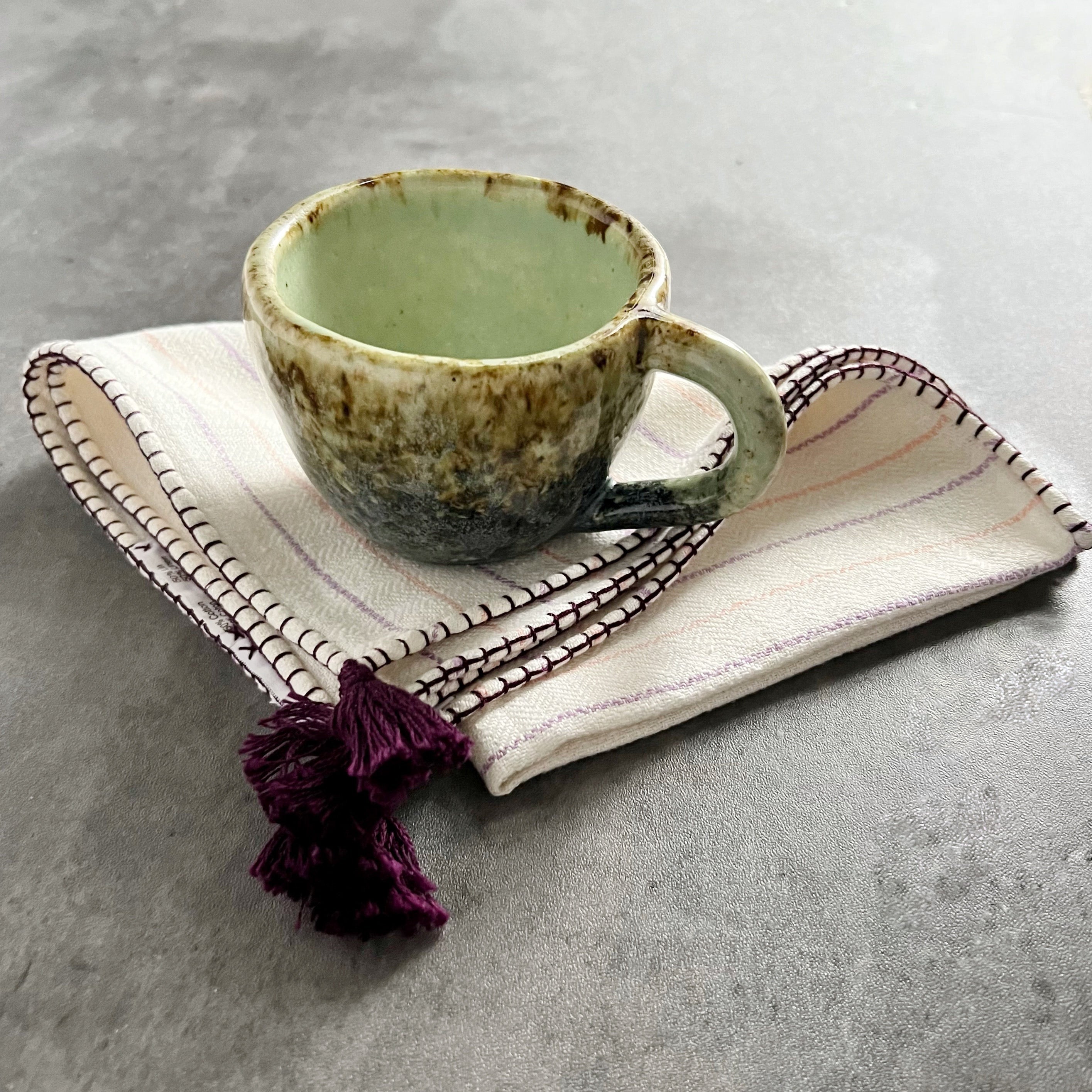 Lighter green and brown handmade coffee cup from Mexico