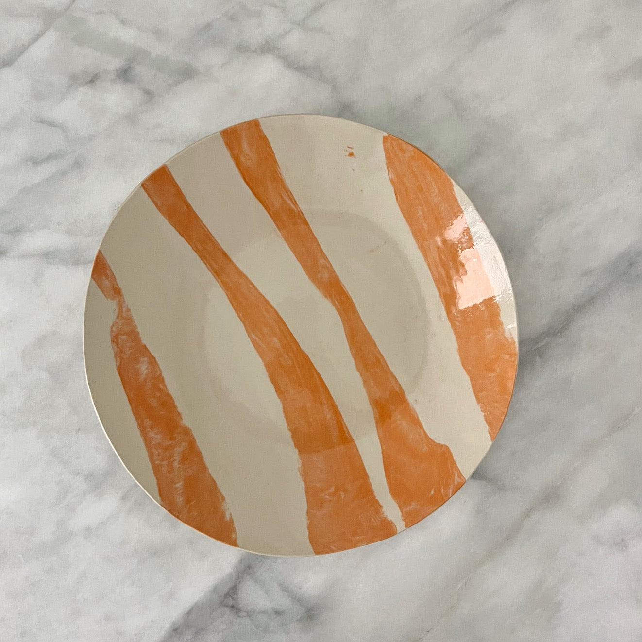 one of a kind ceramic orange and off white plates made in Corsica
