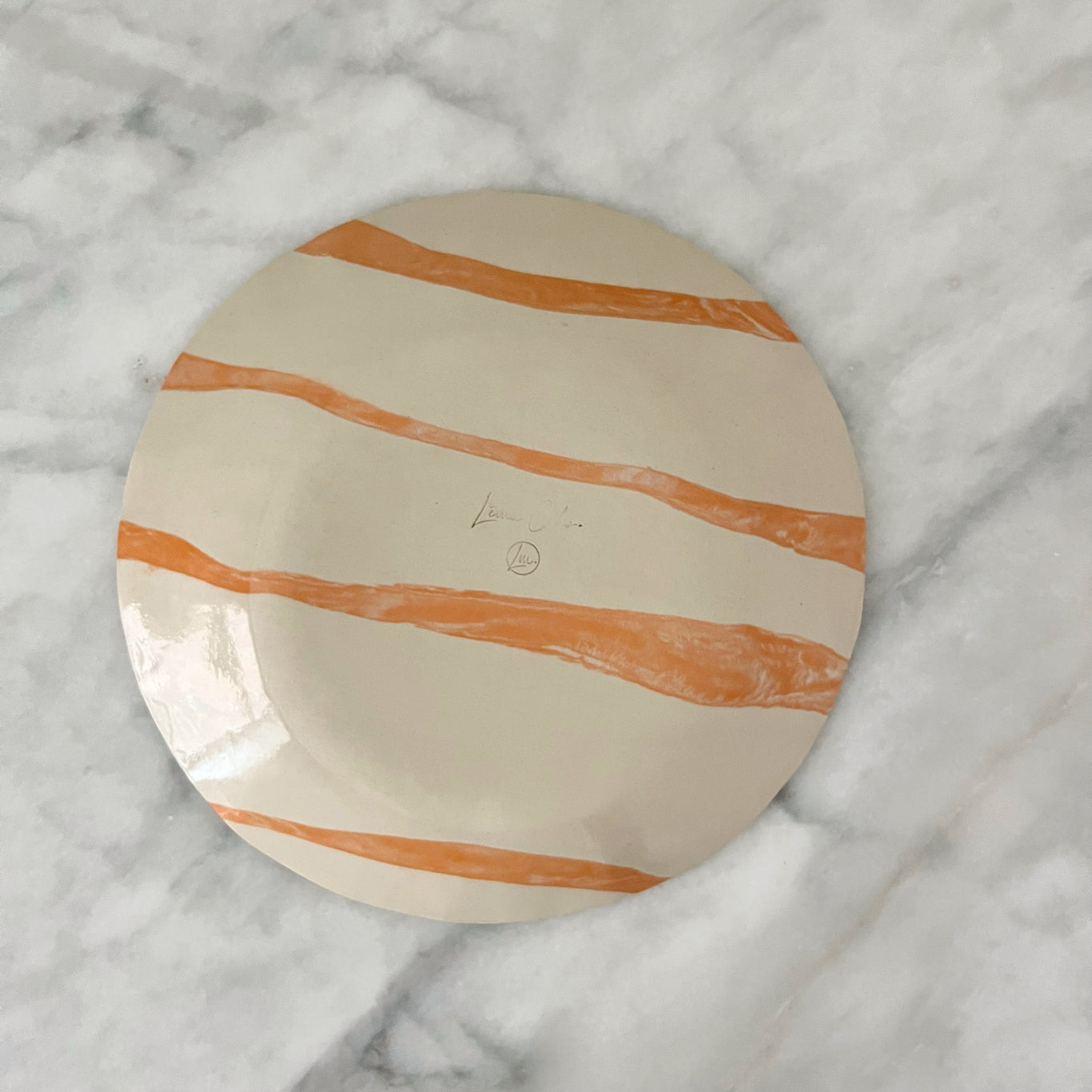 one of a kind ceramic orange and off white plates made in Corsica